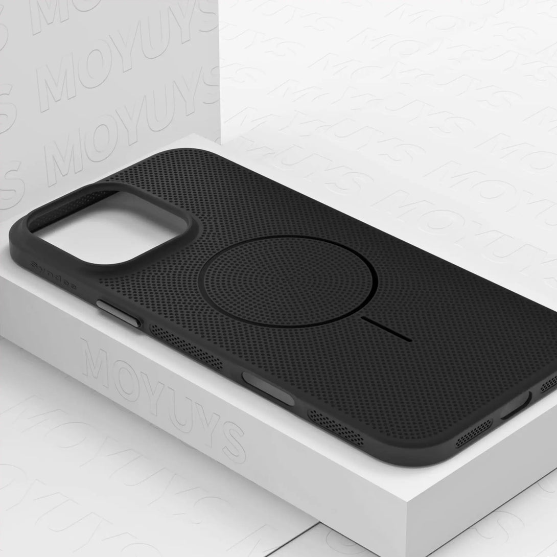 Black iPhone case with wireless charging pad on a white surface