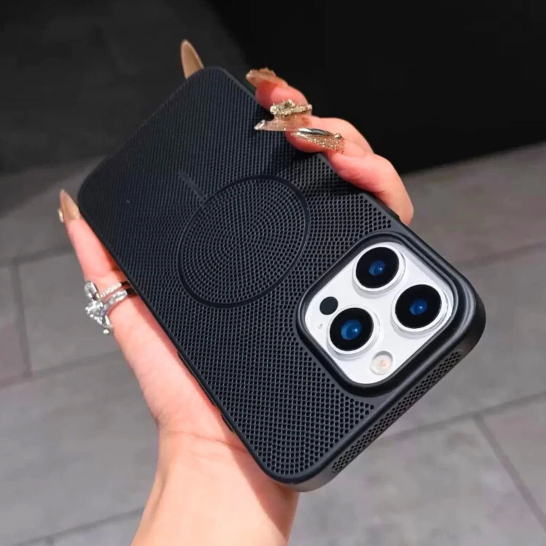Black silicone iPhone case held by a hand with a blurred background