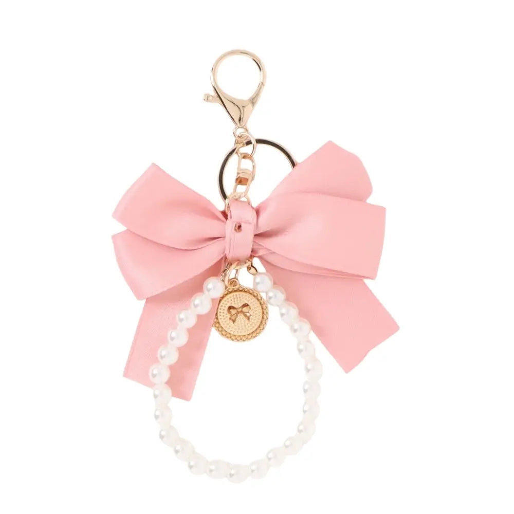 Light pink satin bow phone wristlet with pearl beads and gold keychain clip.