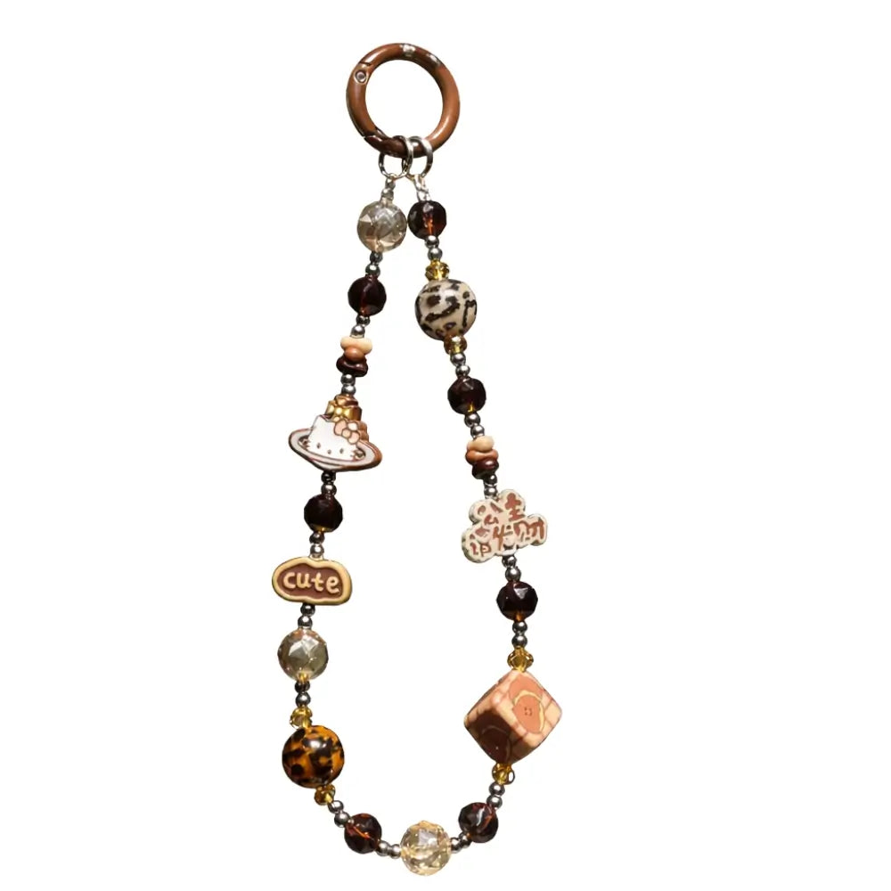 Flatlay of retro brown and amber pearl phone strap with unique leopard print beads and gold spacers