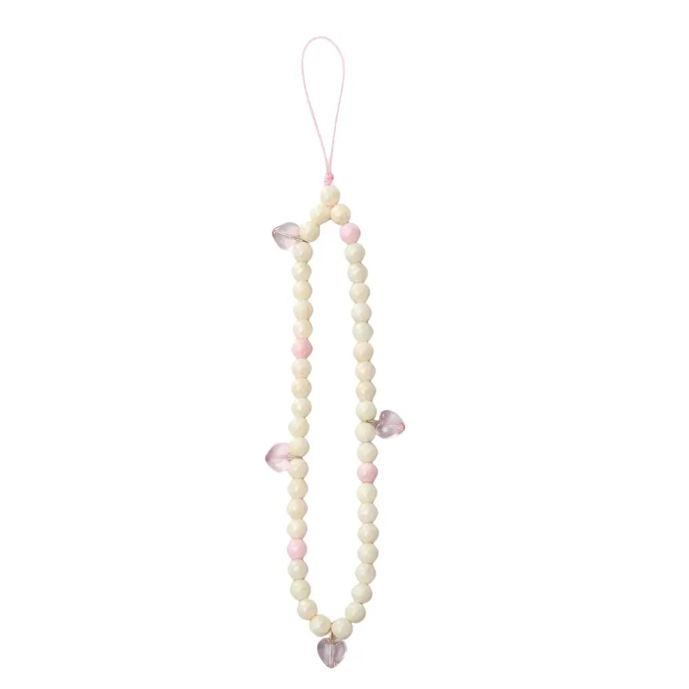 Pastel pink and cream Flower phone charm with beaded pearl featuring translucent hearts and pearl finish for soft aesthetic.